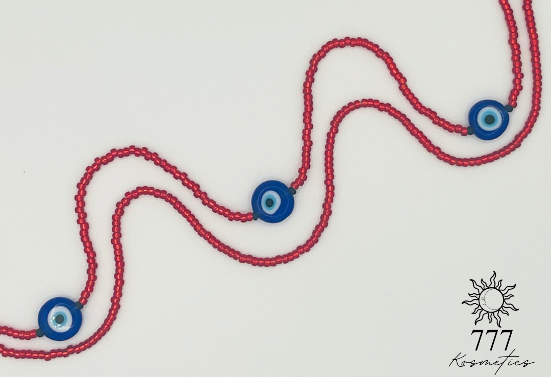 Waist Beads composed of red seed beads, accented with matte black beads and three blue Nazar (Evil eye)