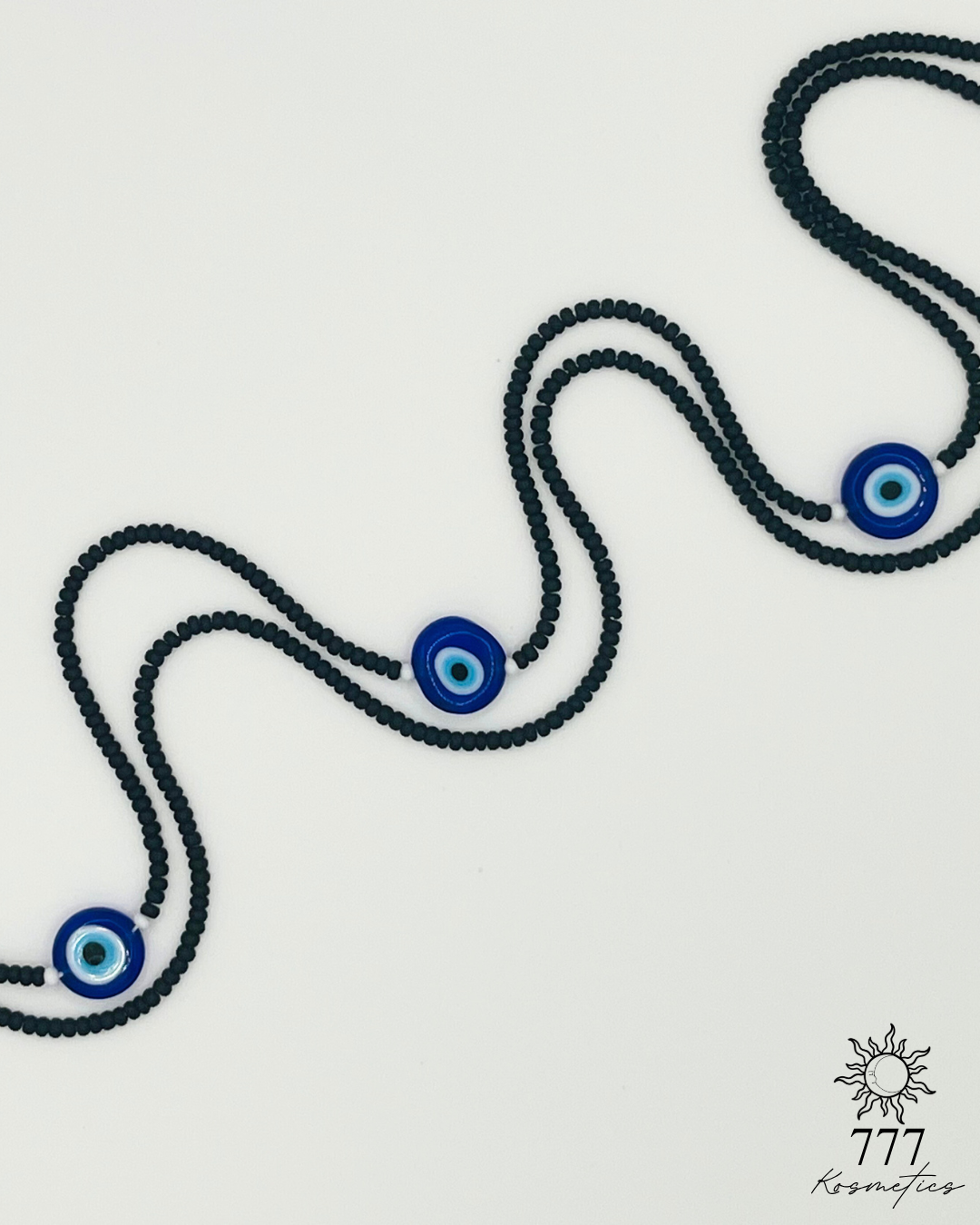 Waist Beads composed of matte black seed beads, accented white beads and three blue Nazar (Evil eye)