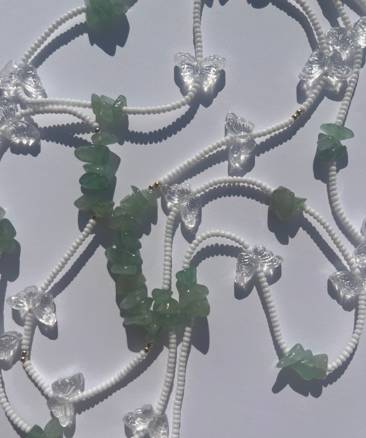 "Lucky Meadow" tie on waist beads made with genuine green aventurine crystal chips, glass butterflies, 14k gold filled beads, and white beads. Made with high quality, mildew resistant string. 