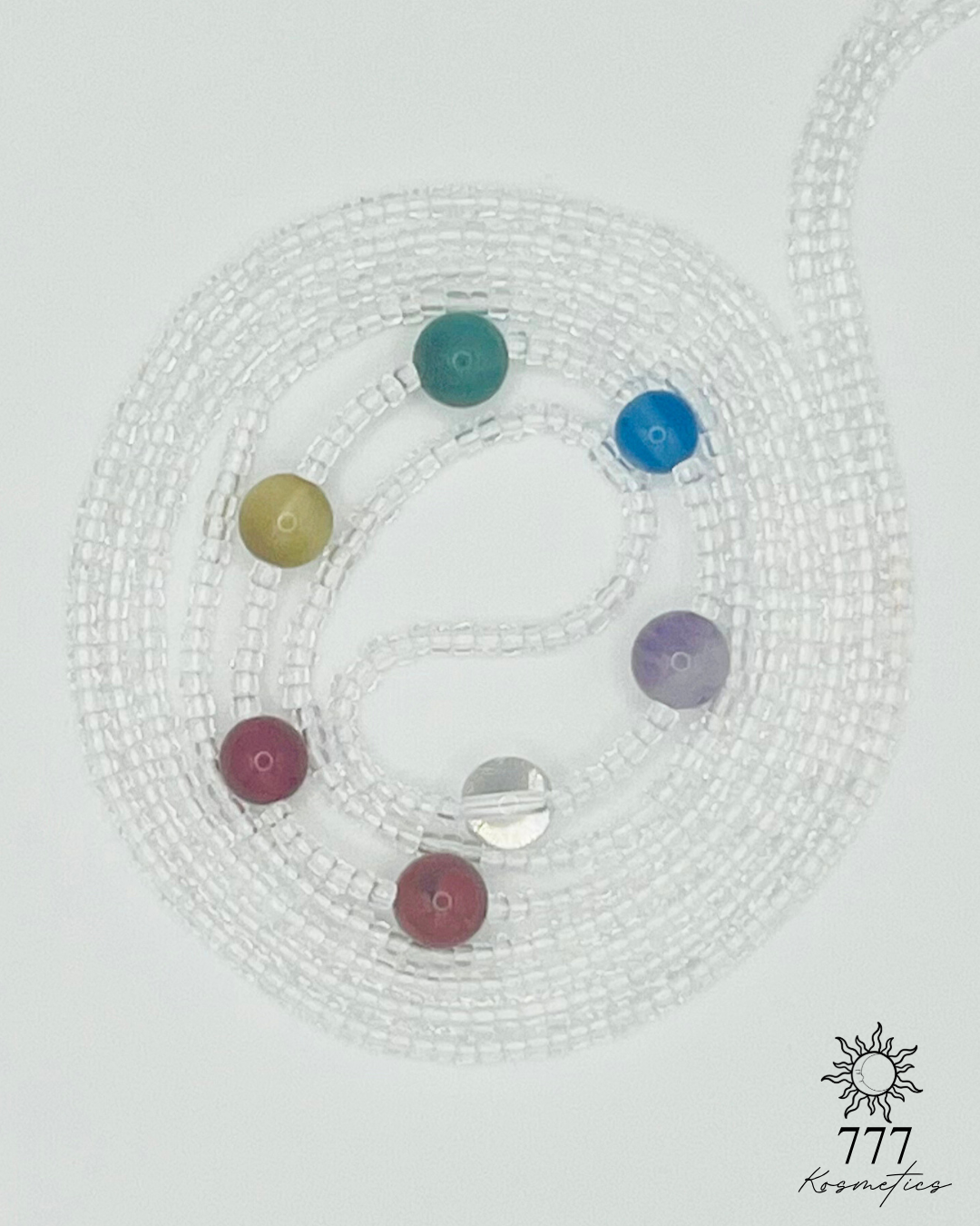 Waist beads with clear seed beads. Includes genuine red jasper, carnelian, honey tiger eye, green aventurine, blue agate, banded amethyst, and clear quartz gemstones. 
