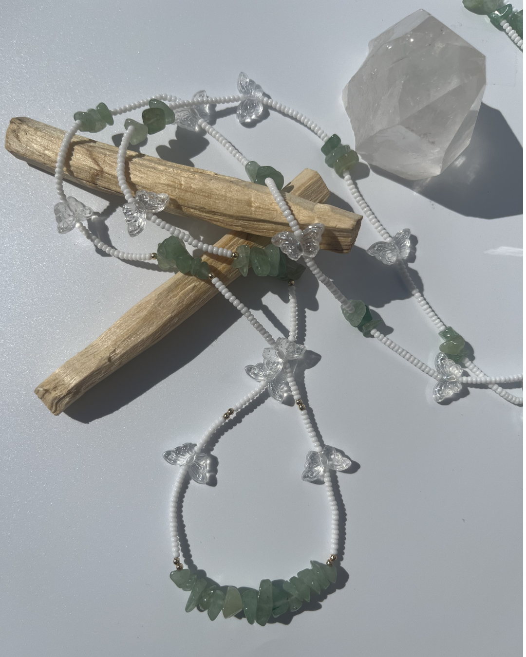 "Lucky Meadow" tie on waist beads made with genuine green aventurine crystal chips, glass butterflies, 14k gold filled beads, and white beads. Made with high quality, mildew resistant string. 