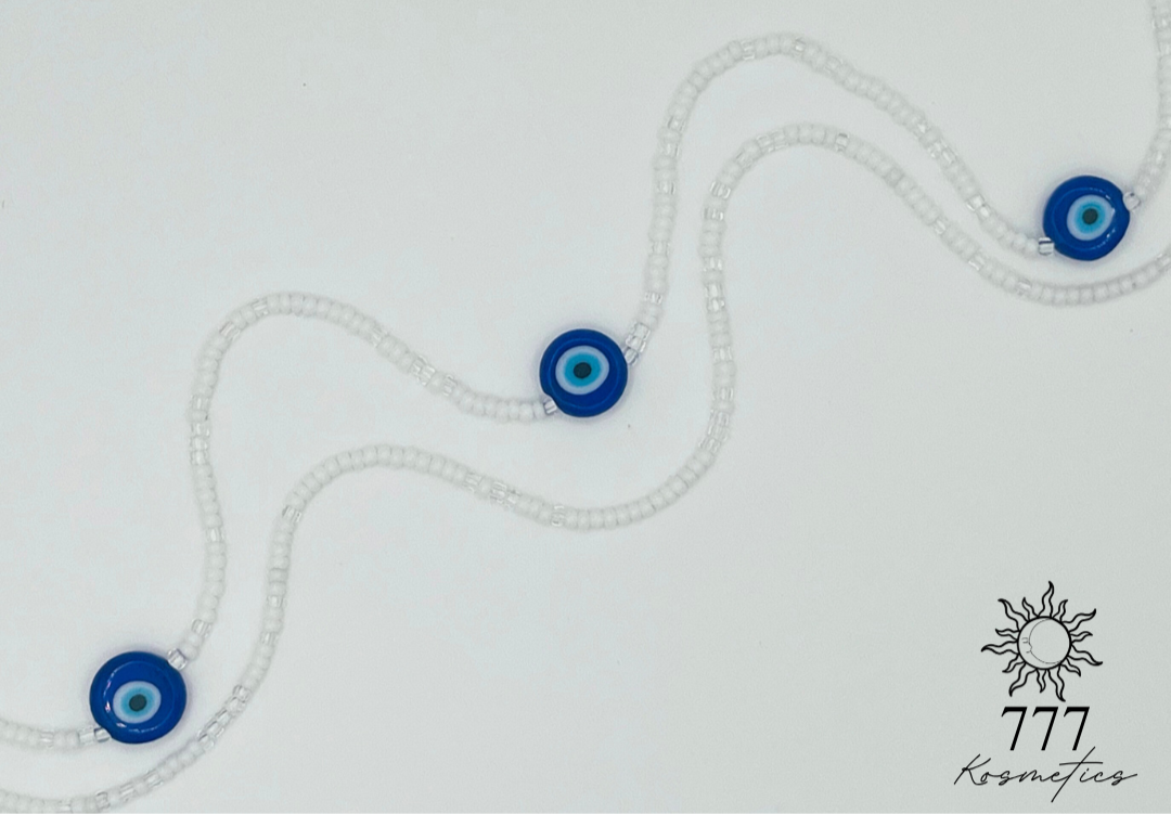 Waist Beads composed of clear and white seed beads, accented with three blue Nazar (Evil eye)