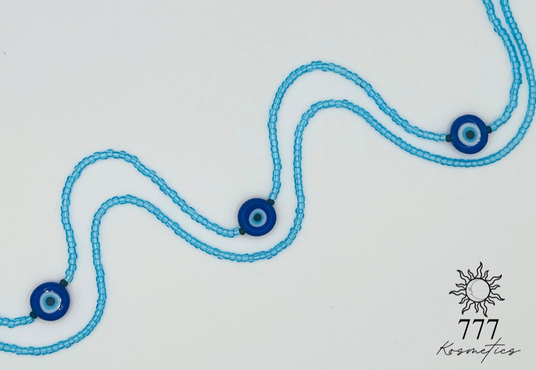 Waist Beads composed of light blue seed beads, accented with matte black beads and three blue Nazar (Evil eye)