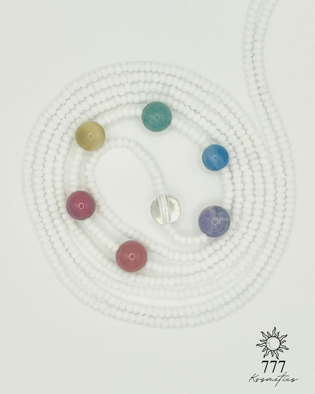 Waist beads with white seed beads. Includes genuine red jasper, carnelian, honey tiger eye, green aventurine, blue agate, banded amethyst, and clear quartz gemstones. 