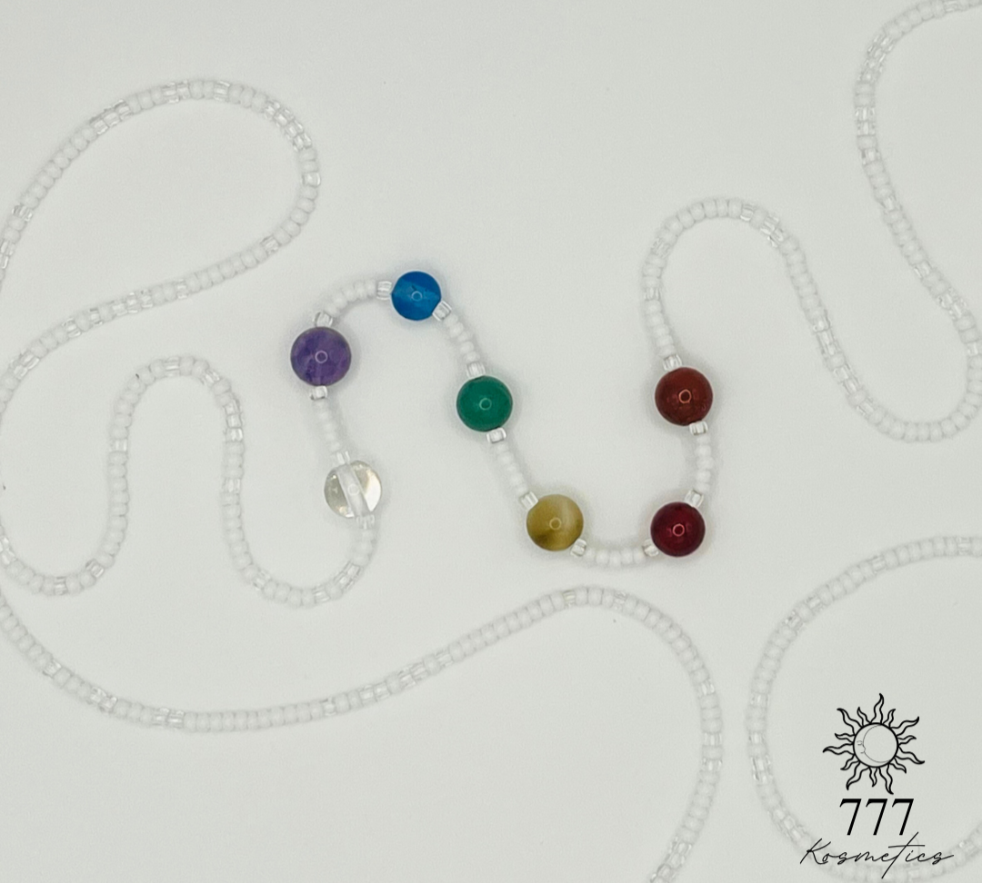 Waist beads with clear and white seed beads. Includes genuine red jasper, carnelian, honey tiger eye, green aventurine, blue agate, banded amethyst, and clear quartz gemstones. 
