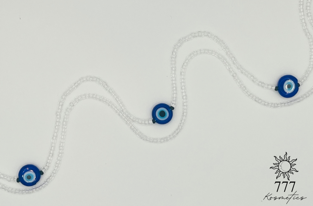 Waist Beads composed of clear seed beads, accented with matte black beads and three blue Nazar (Evil eye)